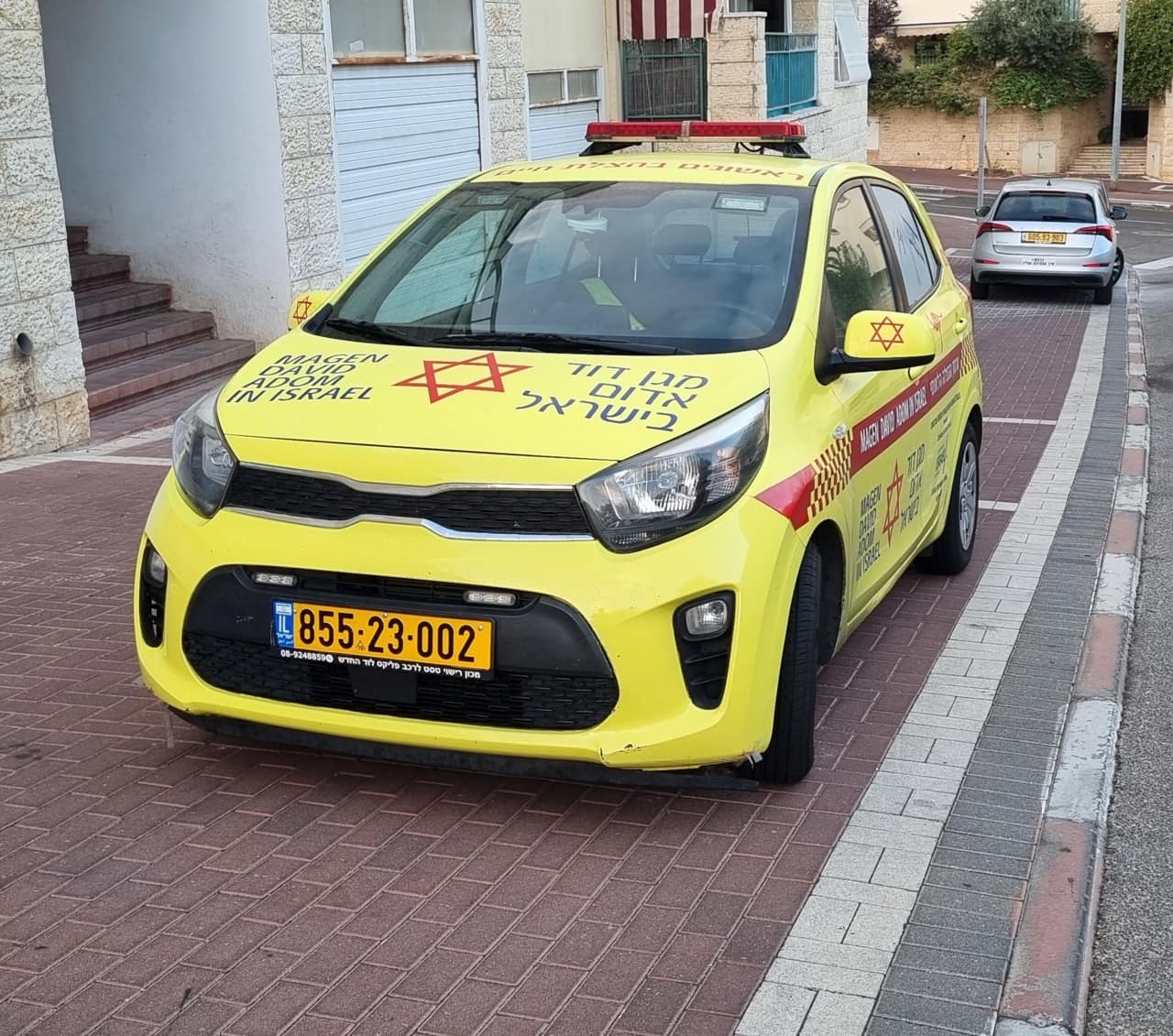 A yellow Magen David Adom rapid-response vehicle parked on an Israeli residential street